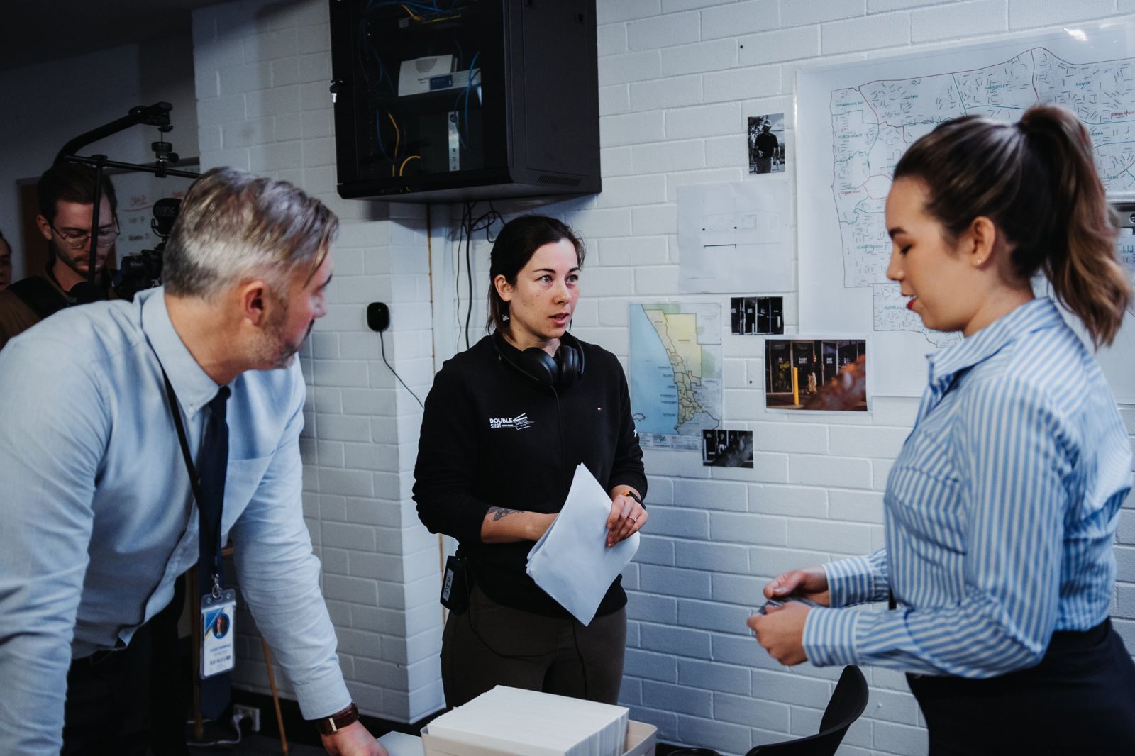 Kelly giving direction to two actors between takes