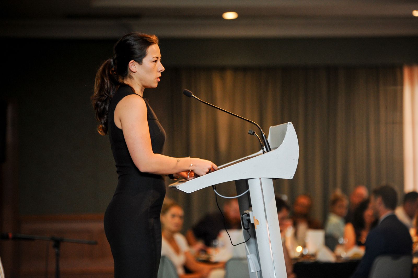 Kelly speaking at the lectern at the Duxton Hotel